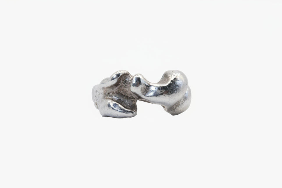 Silver ring with a unique, organic design on a white background