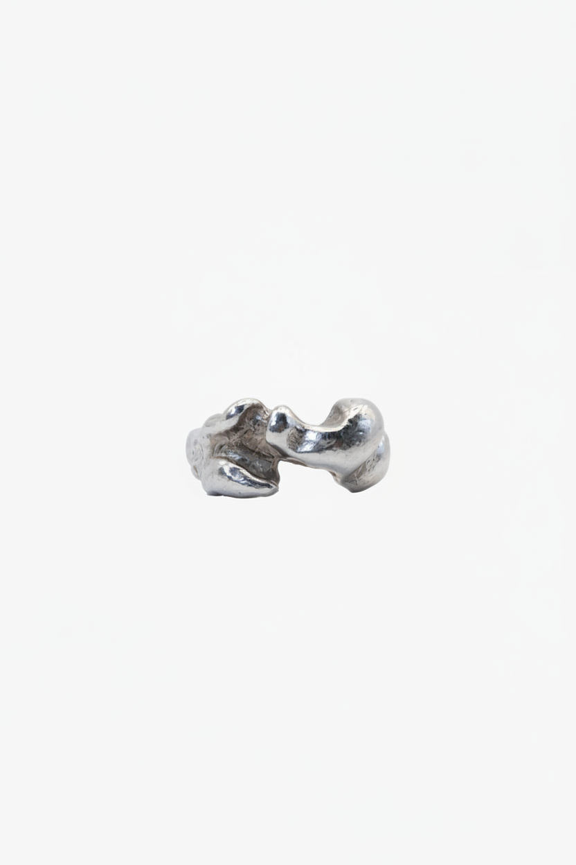 Silver ring with a unique, organic design on a white background
